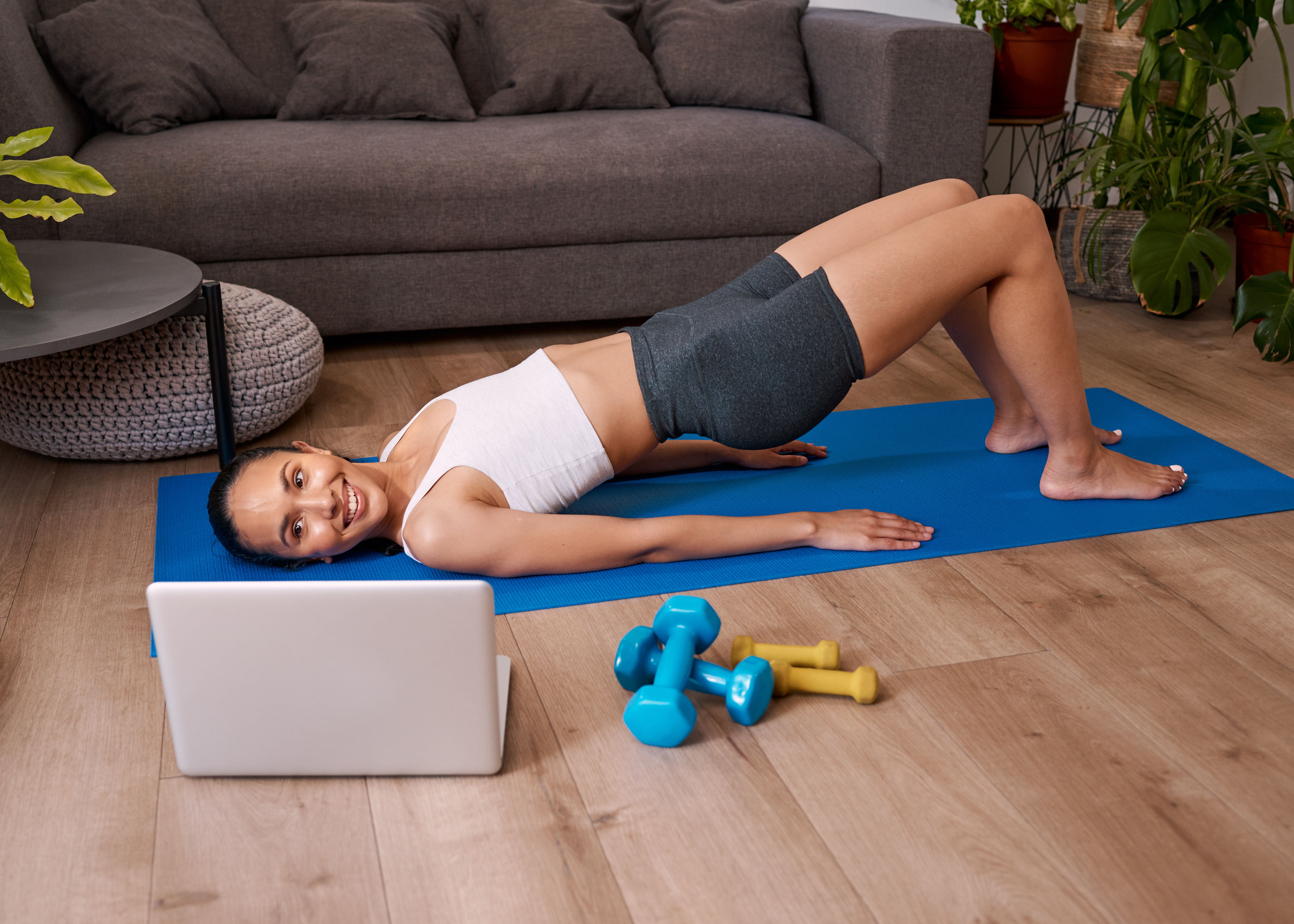 Woman doing bridge exercise while watching video
