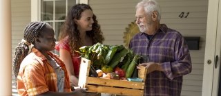 Neighbors delivering food to another neighbor