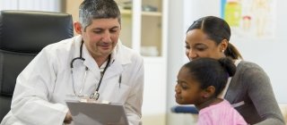 doctor talking to parent and child