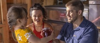 family with maple syrup jar