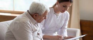 Provider talking with a patient over paperwork