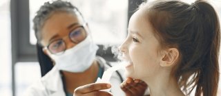 Child with asthma being checked by a doctor