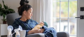 Woman breastfeeding with pump