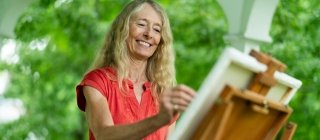 Woman painting on her porch