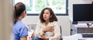 Adult female patient talks with nurse