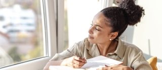 Woman Journaling by Window