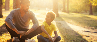 Father and son sitting together and talking