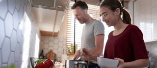 father and daughter making soup together