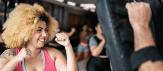 Woman smiling while taking a self defense class