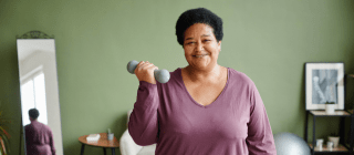 Woman exercising at home with dumbbells