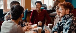 a group of people chatting at a cafe