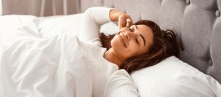 woman stretching in bed after restful sleep