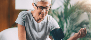 Senior testing blood pressure with a cuff
