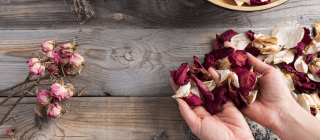 hands making potpourri with rose petals