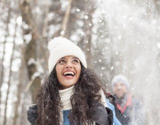 Woman hiking in the woods in winter