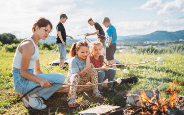 family camping, setting up a tent and roasting marshmallows