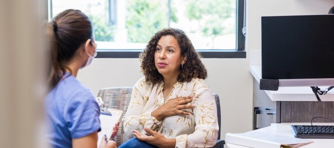 Adult female patient talks with nurse