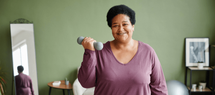 Woman exercising at home with dumbbells